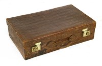 Lot 112 - A crocodile skin suitcase
