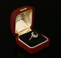 Lot 10 - An 18ct gold sapphire and diamond cluster ring