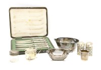 Lot 96 - A pair of silver pepperettes with blue glass liners and pierced detail