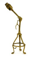 Lot 966 - An Arts and Crafts brass combination electric table and wall light