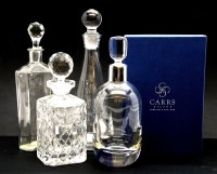 Lot 339 - A silver plated and oak tantalus fitted three hobnail cut decanters