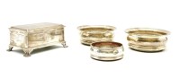 Lot 135 - A pair of silver wine coasters with hardwood bases