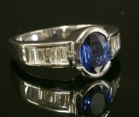 Lot 294 - A Continental white gold sapphire and diamond ring with an oval mixed cut sapphire