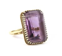 Lot 5 - A gold single stone emerald cut amethyst ring