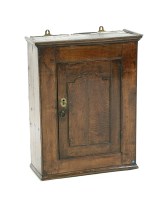 Lot 563 - An 18th century oak spice cabinet