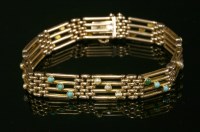 Lot 65 - An Edwardian four row gold gate bracelet