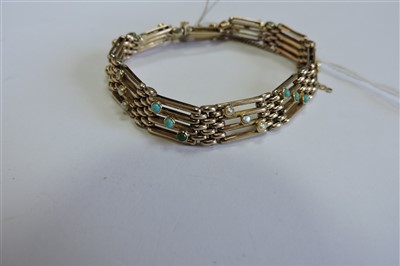 Lot 65 - An Edwardian four row gold gate bracelet