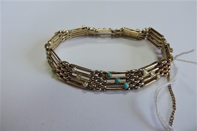 Lot 65 - An Edwardian four row gold gate bracelet