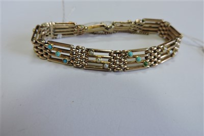 Lot 65 - An Edwardian four row gold gate bracelet