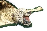 Lot 619 - A leopard-skin rug
