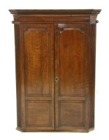 Lot 519 - An oak corner cupboard