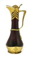 Lot 374 - An Osiris pewter and gilt-mounted claret jug