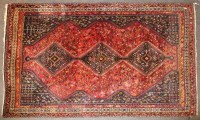 Lot 598 - A large red ground rug