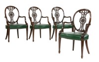 Lot 621 - A set of four Hepplewhite-style mahogany elbow chairs