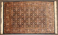 Lot 719A - A Persian rug having brick red and green fields