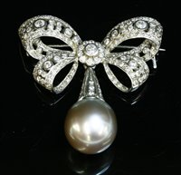 Lot 334 - A white gold Tahitian cultured pearl and diamond bow brooch