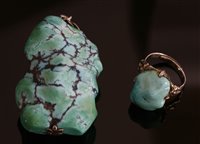 Lot 255 - A freeform turquoise matrix pendant