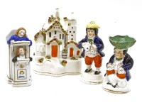 Lot 254 - A Staffordshire pottery open salt and pepper in the form of seated figures