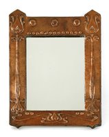 Lot 55 - An Arts & Crafts embossed copper mirror