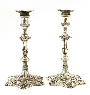 Lot 100 - A pair of George II silver candlesticks
