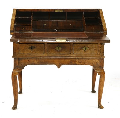 Lot 790 - A figured walnut bureau on stand