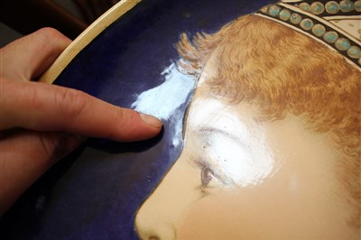 Lot 23 - A Minton's Art Pottery Studio charger depicting female portrait
