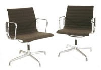 Lot 306 - Two Charles and Ray Eames swivel armchairs