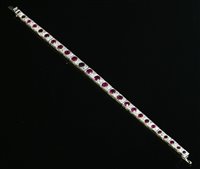 Lot 178 - An Art Deco ruby and diamond line bracelet