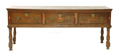 Lot 546 - A three-drawer oak dresser base