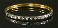 Lot 318 - A yellow and white gold diamond set hinged bangle