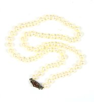 Lot 90 - A pearl necklace with silver and garnet clasp