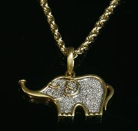 Lot 20 - A two colour gold diamond set elephant pendant