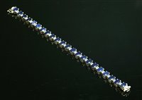 Lot 296 - An 18ct white gold sapphire and diamond line bracelet