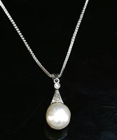Lot 147 - A natural saltwater pearl and diamond pendant