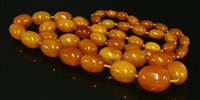 Lot 203 - A single row graduated, olive shaped, butterscotch amber bead necklace