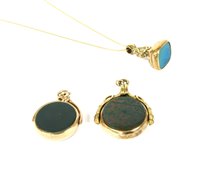 Lot 1 - A 9ct gold swivel fob, rub set with a circular...