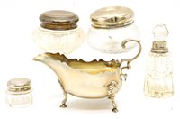 Lot 120 - A silver sauce boat, Sheffield, 1925, a silver topped string box