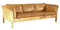 Lot 596 - A Stouby tan leather three seat settee