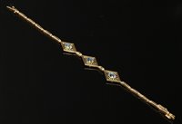 Lot 116 - An Art Deco gold and platinum aquamarine bracelet