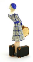 Lot 80 - A Goldscheider figure of a woman holding a hat box, holding two suitcases