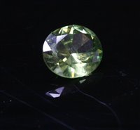 Lot 120 - An unmounted oval mixed cut green garnet