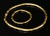 Lot 374 - A yellow and rose gold necklace and bracelet suite, by Tannler