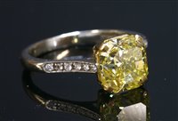 Lot 538 - A yellow and white gold single stone fancy vivid yellow diamond ring