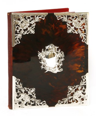 Lot 54 - A tortoiseshell desk blotter with ornate silver mounts
