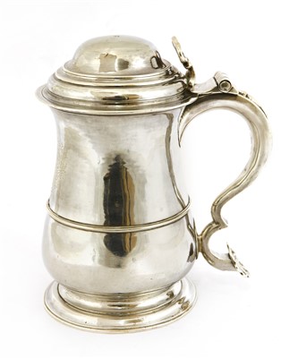 Lot 83 - A George II provincial baluster shape tankard and cover