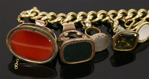 Lot 13 - An 18ct gold curb link bracelet with later 9ct gold padlock and eleven assorted seals