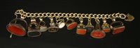 Lot 13 - An 18ct gold curb link bracelet with later 9ct gold padlock and eleven assorted seals