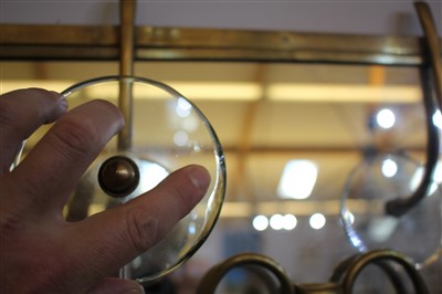 Lot 123 - A mirrored brass coat rack