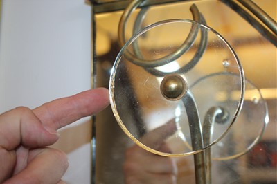 Lot 123 - A mirrored brass coat rack