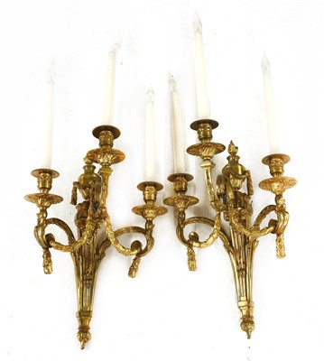 Lot 267A - A pair of gilt brass three-branch wall lights